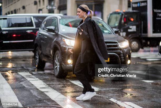 Celine Aagaard wearing black suit, wool coat, head band seen outside Boss on February 7, 2018 in New York City.