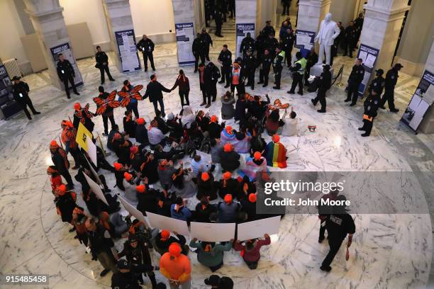 Police arrest immigration activists conducing an act of civil disobediance in the rotunda of the Russell Senate Office Building on February 7, 2018...