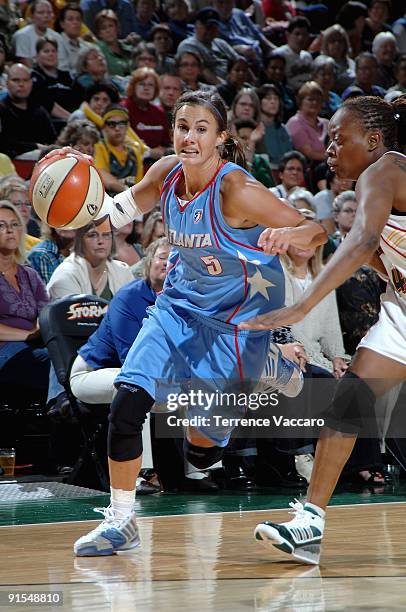 Shalee Lehning of the Atlanta Dream drives to the basket past Shannon Johnson of the Seattle Storm during the WNBA game on August 29, 2009 at the Key...