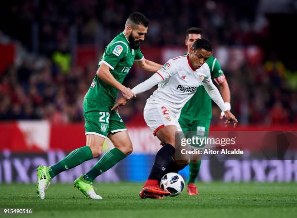 Dimitrios Siovas of Leganes competes for the ball with Luis Muriel of Sevilla during the Copa del Rey semi-final second leg match between Sevilla FC...