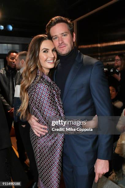 Actors Elizabeth Chambers and husband Armie Hammer pose for a photo at BOSS Menswear - Front Row at New York Fashion Week Mens' on February 7, 2018...