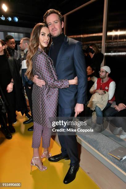 Actors Elizabeth Chambers and husband Armie Hammer pose for a photo at BOSS Menswear - Front Row at New York Fashion Week Mens' on February 7, 2018...