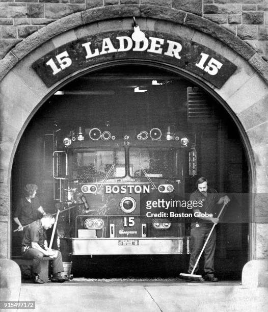 Boston firefighters conduct morning chores at a Boylston Street firehouse on July 12, 1977.