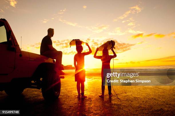 portrait of family of surfers at sunset - california beach surf stock pictures, royalty-free photos & images