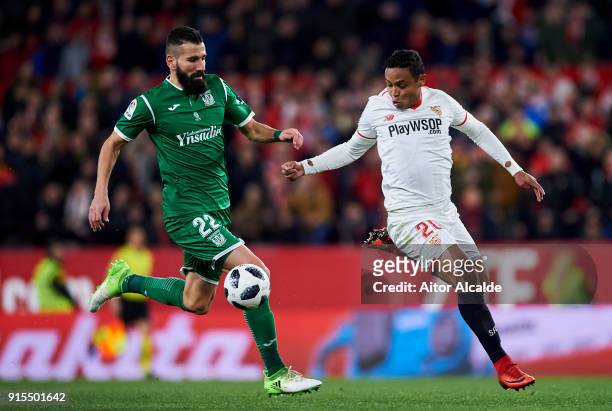 Dimitrios Siovas of Leganes competes for the ball with Luis Muriel of Sevilla during the Copa del Rey semi-final second leg match between Sevilla FC...