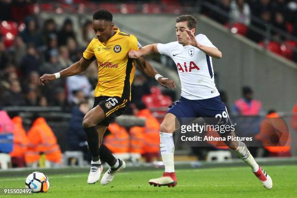 Shawn McCoulsky of Newport County is challenged by Harry Winks of Tottenham Hotspur during the Fly Emirates FA Cup Fourth Round Replay match between...
