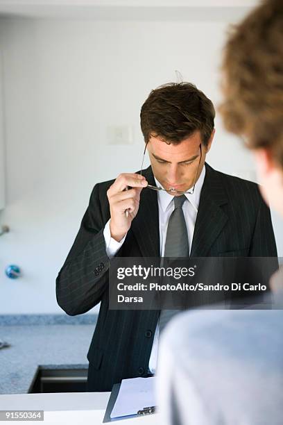 businessman reviewing document, associate patiently waiting - clipboard and glasses stock pictures, royalty-free photos & images