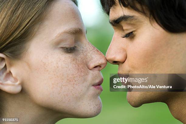 young couple touching noses, puckering, profile - almost kissing stock pictures, royalty-free photos & images