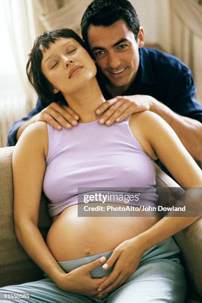 man massaging pregnant wife's shoulders - girlfriend massage ストックフォトと画像