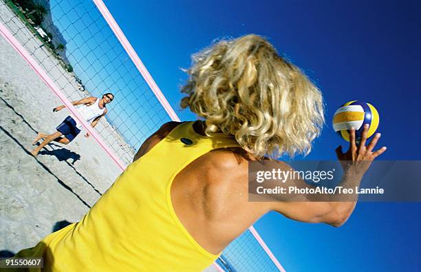 male playing beach volleball preparing to hit ball - beach volley stockfoto's en -beelden