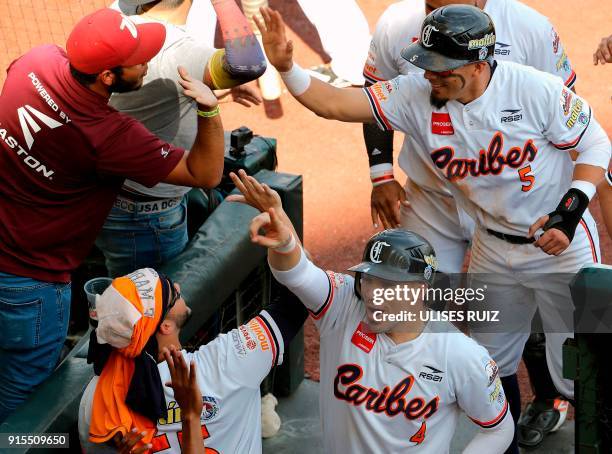 Niuman Romero and Rafael Ortega of Venezuela's Caribes de Anzoategui celebrate after scoring against the Criollos de Caguas of Puerto Rico during the...