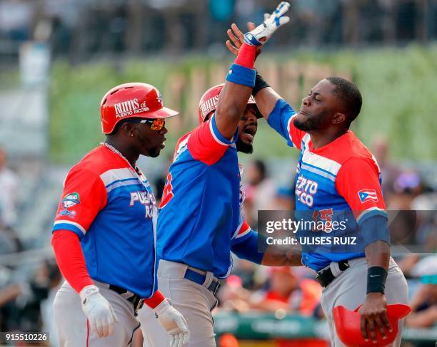 Anthony Garcia of Puerto Rico's Criollos de Caguas celebrates after scoring against Venezuela's Caribes de Anzoategui during the Caribbean Baseball...