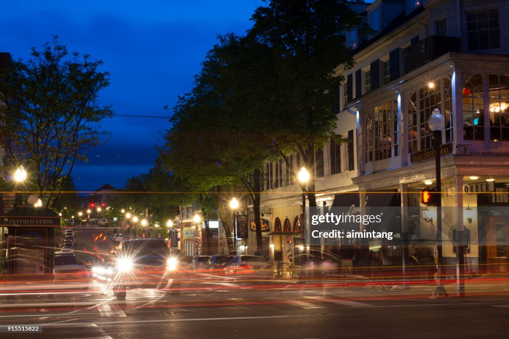 Night traffic in the town of State College with people standing outside the Corner Room restaurant