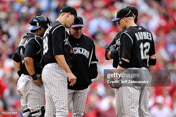 Pitching coach Bob Apodaca of the Colorado Rockies talks with starting pitcher Ubaldo Jimeniz in the bottom of the fifth inning against the...