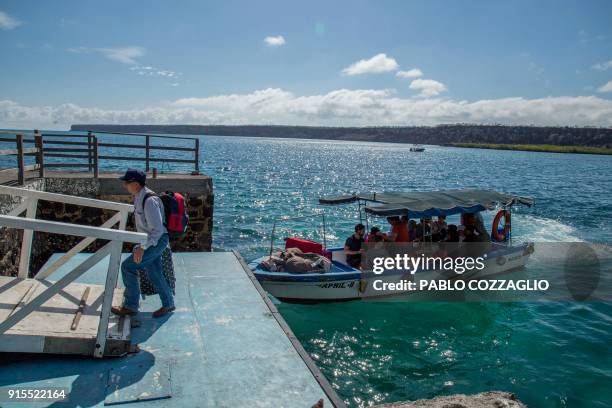 Group of tourists arrive at Santa Cruz Island after crossing the Itabaca channel in Galapagos, Ecuador, on January 21, 2018. - Ecuador's growing...