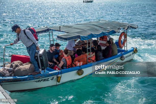 Group of tourists arrive by boat to Santa Cruz Island after crossing the Itabaca channel in Galapagos, Ecuador, on January 21, 2018. - Ecuador's...