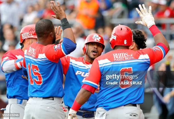 Jesmuel Valentin of Puerto Rico's Criollos de Caguas celebrates with teammates their passage to the final match against Venezuela's Caribes de...