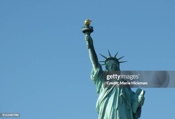 photo of the upper part of the statue of liberty located in new york harbor in new york city. - marie hickman stock-fotos und bilder