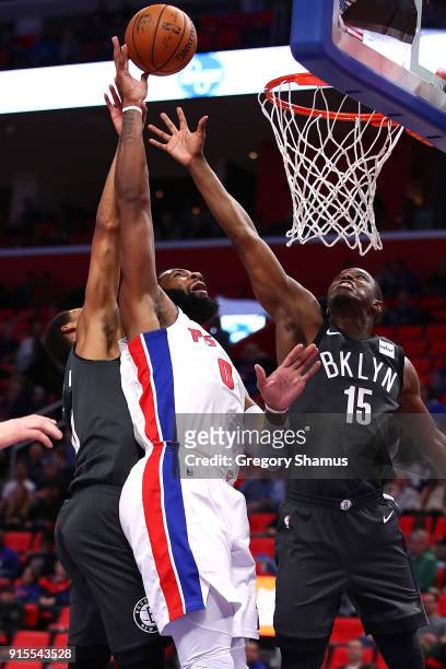 Andre Drummond of the Detroit Pistons gets a shot off between Isaiah Whitehead and James Webb III of the Brooklyn Nets during the first half at...