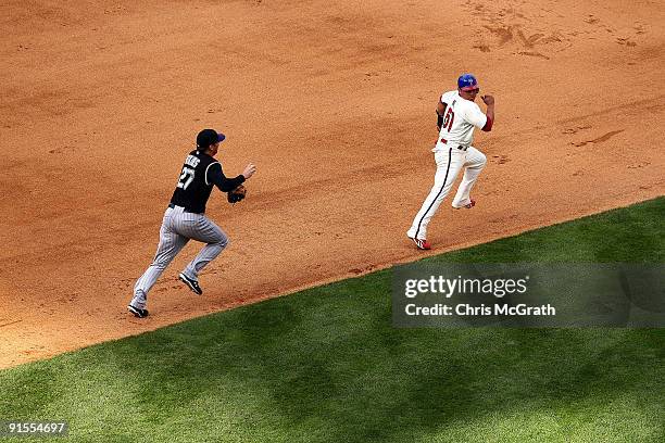 Carlos Ruiz of the Philadelphia Phillies gets caught in a run down against Garrett Atkins of the Colorado Rockies in the bottom of the sixth inning...