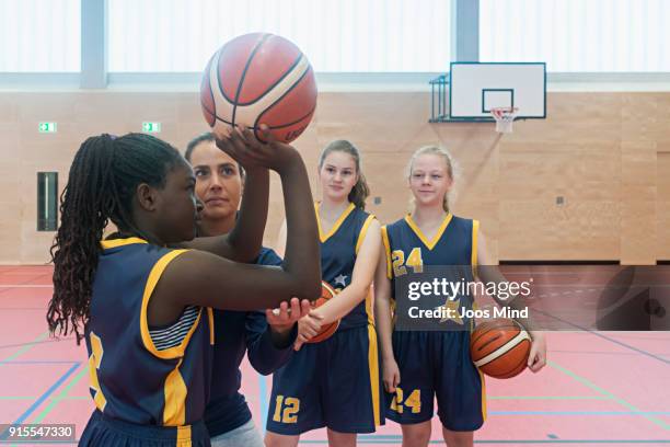female coach teaching basketball exercises - basketball team stock pictures, royalty-free photos & images
