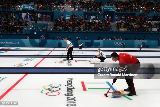 Ba Dexin of China sweeps the ice against Switzerland in the Curling Mixed Doubles Round Robin Session 1 during the PyeongChang 2018 Winter Olympic...