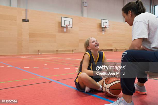 Female coach motivates young basketball player