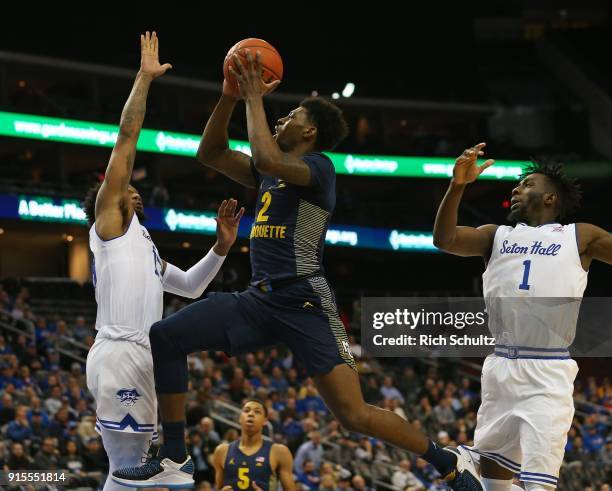 Sacar Anim of the Marquette Golden Eagles attempts a shot and is fouled by Myles Powell of the Seton Hall Pirates during the first half of a game at...