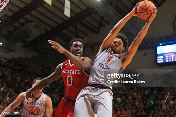 Tyrie Jackson of the Virginia Tech Hokies gets the rebound against Abdul-Malik Abu of the NC State Wolfpack in the first halfat Cassell Coliseum on...
