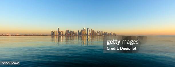 panoramic view of the downtown doha city skyline at sunset, qatar - doha sunset stock pictures, royalty-free photos & images