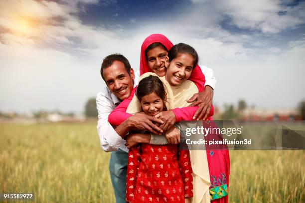 cheerful family portrait - rural india stock pictures, royalty-free photos & images