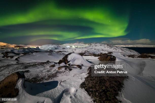 northern lights in the snow-covered mountains - northern mariana islands stock-fotos und bilder