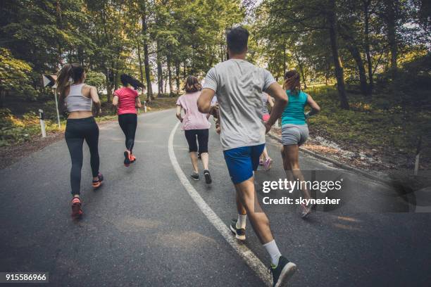 vista posteriore del gruppo competitivo di atleti che corrono una maratona. - 10000 metri foto e immagini stock