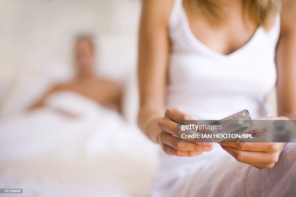 Woman taking contraceptive pill
