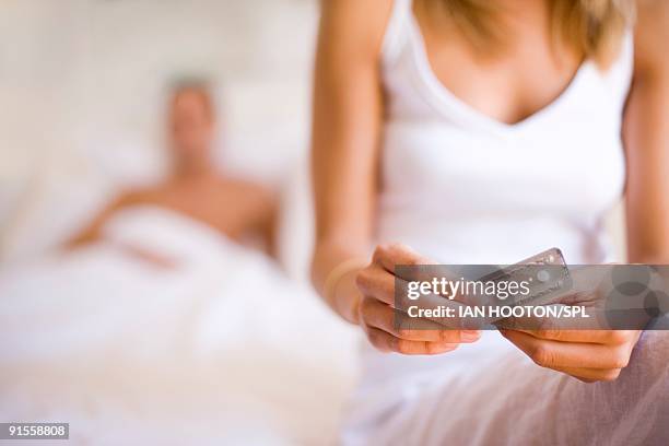 woman taking contraceptive pill - contraceptive stock-fotos und bilder