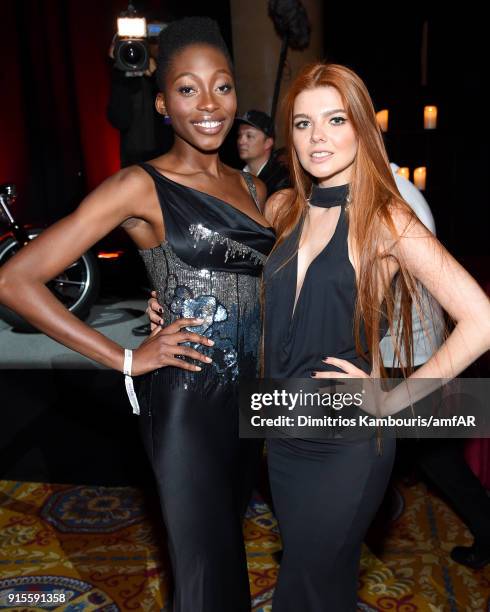 Models Oluwatoniloba Dreher-Adenuga and Klaudia Anna Giez attends the 2018 amfAR Gala New York at Cipriani Wall Street on February 7, 2018 in New...