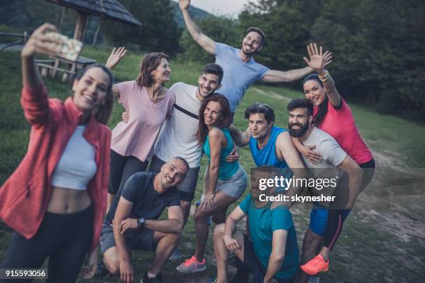 grote groep gelukkig atleten nemen van een selfie met mobiele telefoon in de natuur. - race day stockfoto's en -beelden