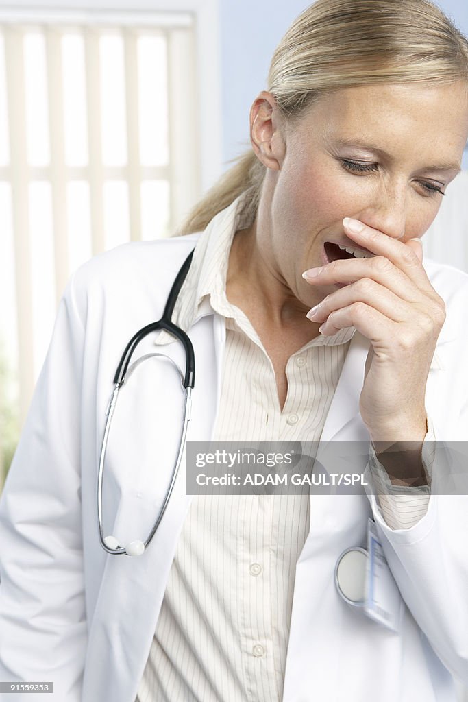 Female doctor yawning