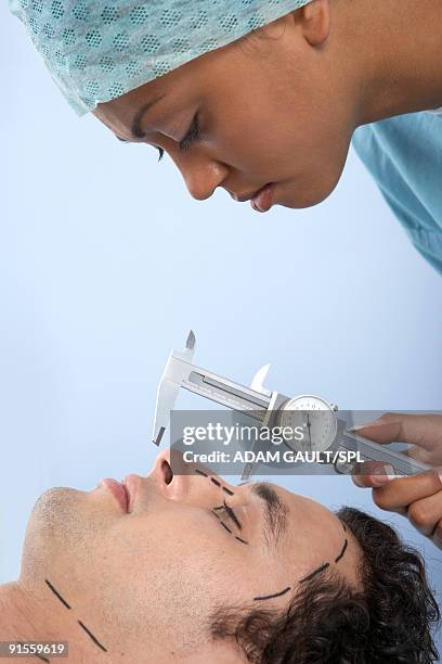 human hand holding vernier caliper to measure patients nose - vernier caliper stock-fotos und bilder