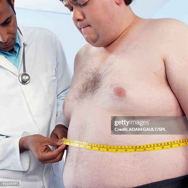 general practitioner measuring waist of obese patient - overweight 40 year old male concerned stock pictures, royalty-free photos & images