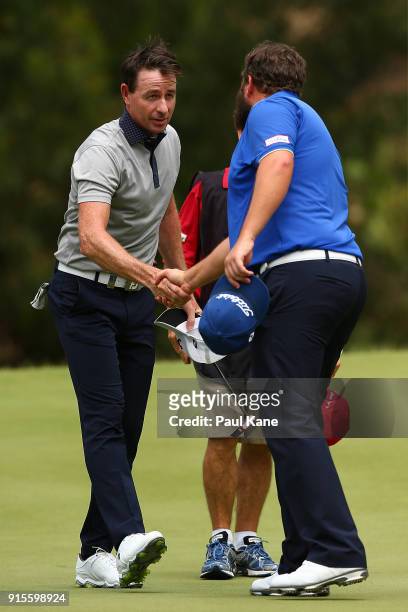 Brett Rumford of Australia shakes hands with Andrew Johnston of England after finishing his round during day one of the World Super 6 at Lake...