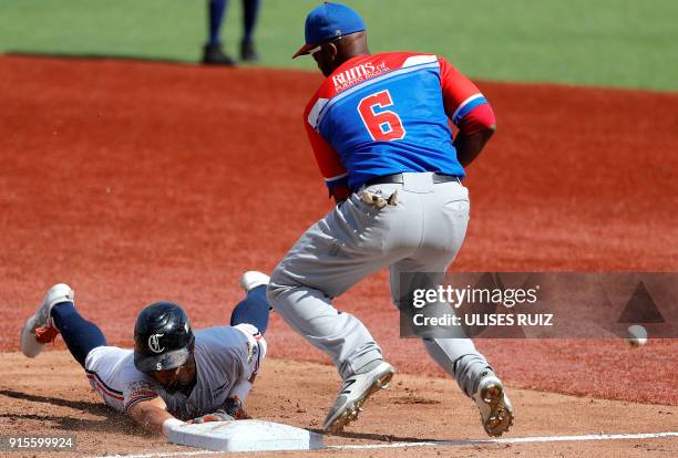 Rafael Ortega , Caribes de Anzoategui of Venezuela, tries to recover at first base before Ruben Gotay , Criollos de Caguas of Puerto Rico, during the...