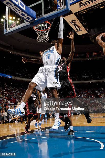 Dwight Howard of the Orlando Magic shoots against Joel Anthony of the Miami Heat during the pre-season game on October 7, 2008 at Amway Arena in...