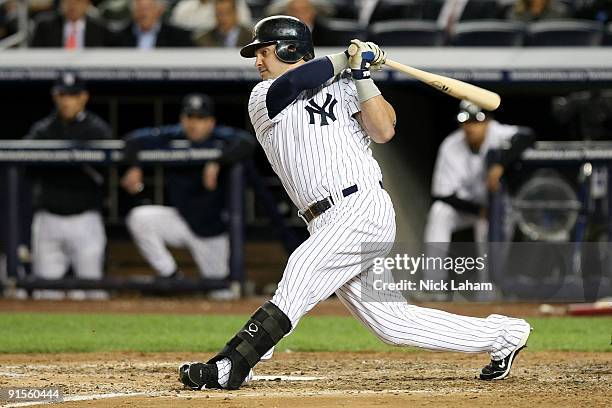 Nick Swisher of the New York Yankees hits an RBI double in the fourth inning against the Minnesota Twins in Game One of the ALDS during the 2009 MLB...
