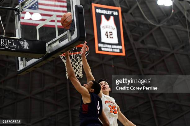 Darnell Foreman of the Pennsylvania Quakers drives to the basket against Alec Brennan of the Princeton Tigers during the first half at L. Stockwell...