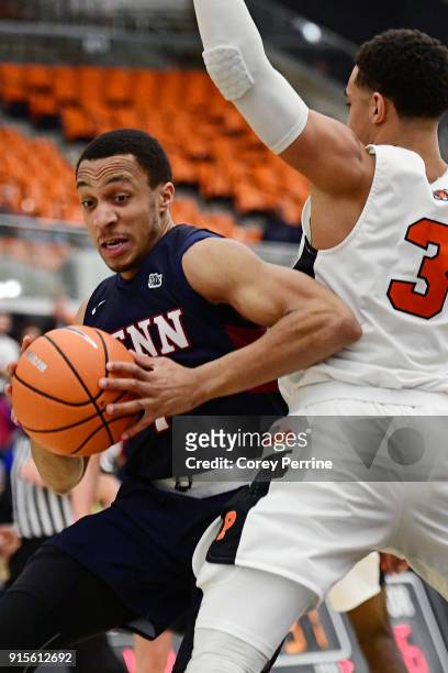 Darnell Foreman of the Pennsylvania Quakers drives past Devin Cannady of the Princeton Tigers during the second half at L. Stockwell Jadwin Gymnasium...