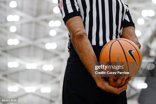 Referee holds the ball during the second half at L. Stockwell Jadwin Gymnasium on February 6, 2018 in Princeton, New Jersey. Penn defeated Princeton...