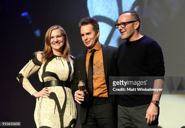 Moderator Krista Smith, actors Sam Rockwell and Clark Gregg pose onstage with The American Riviera Award at The American Riviera Award Honoring Sam...