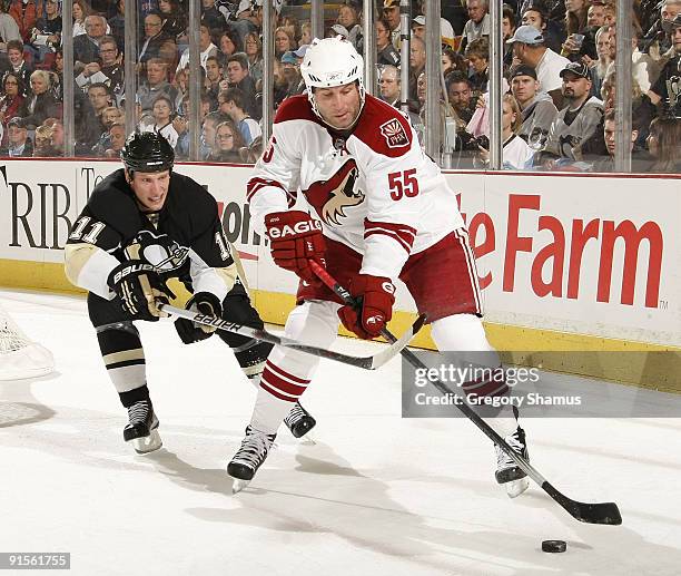 Ed Jovanovski of the Phoenix Coyotes controls the puck in front of Jordan Staal of the Pittsburgh Penguins on October 7, 2009 at Mellon Arena in...