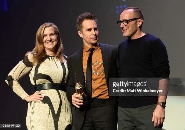 Moderator Krista Smith, actors Sam Rockwell and Clark Gregg pose onstage with The American Riviera Award at The American Riviera Award Honoring Sam...
